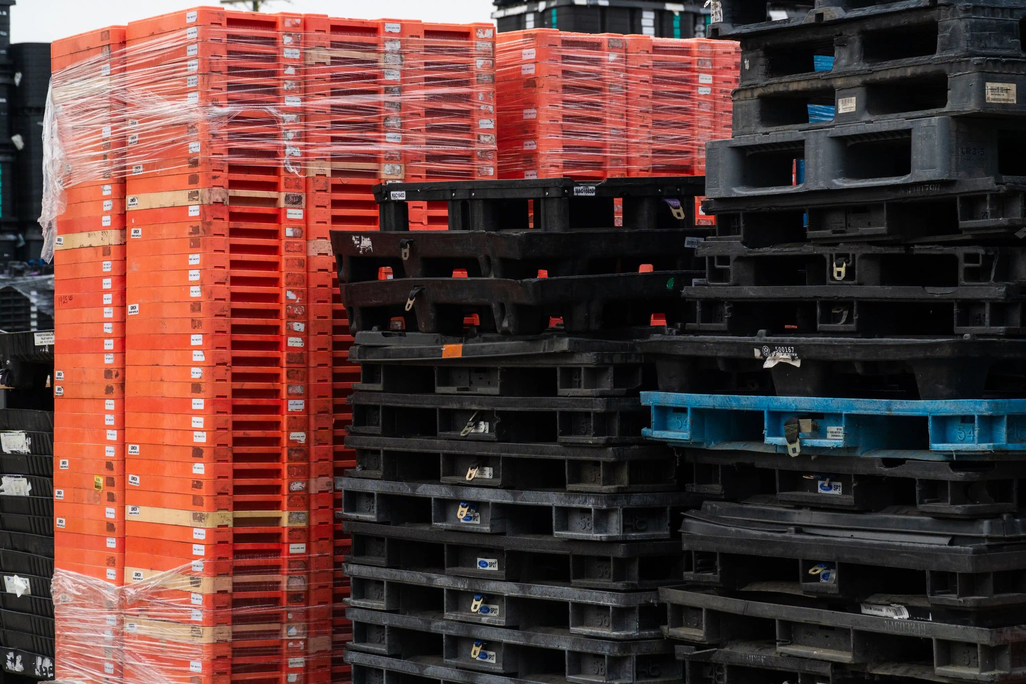 Stacks of reusable plastic pallets and dunnage awaiting recycling in Standish, Michigan. Stacks of reusable plastic pallets and dunnage awaiting recycling in Standish, Michigan.