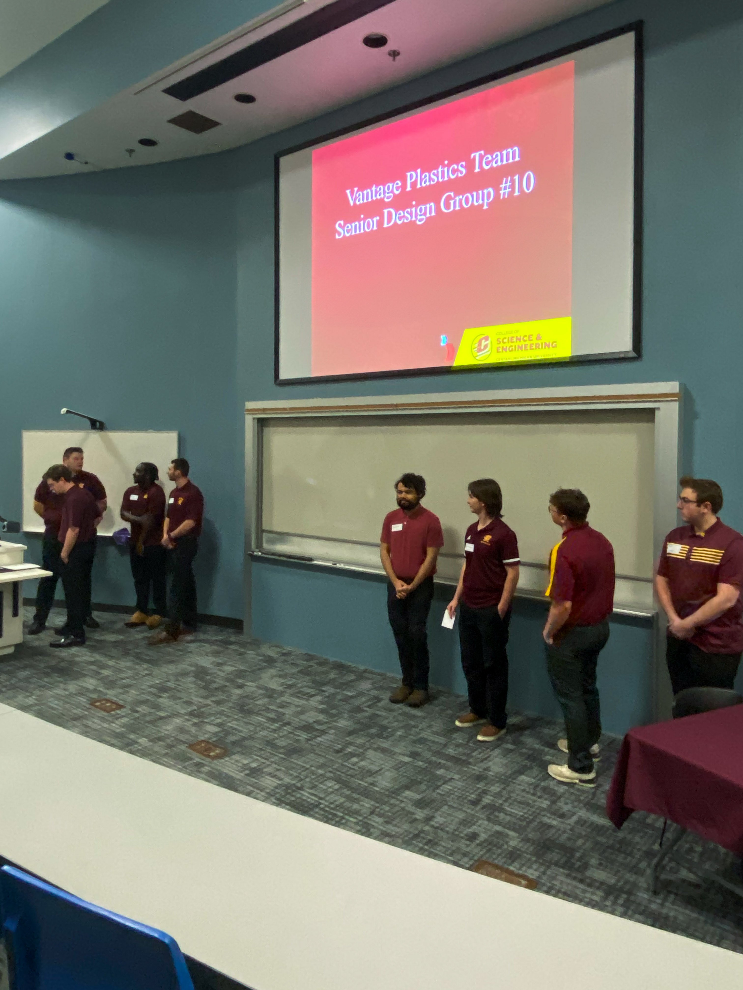 students standing in front for a presentation