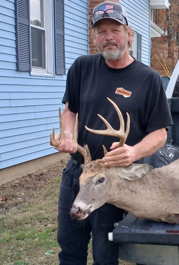 man holding a deer